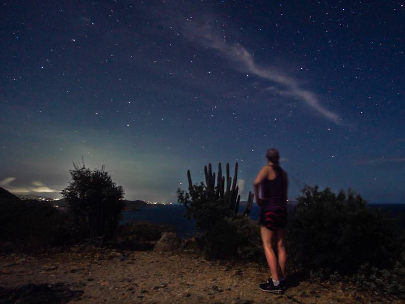 Girl standing near cactus in the dark on the Ram Head Trail in St. John, US Virgin Islands