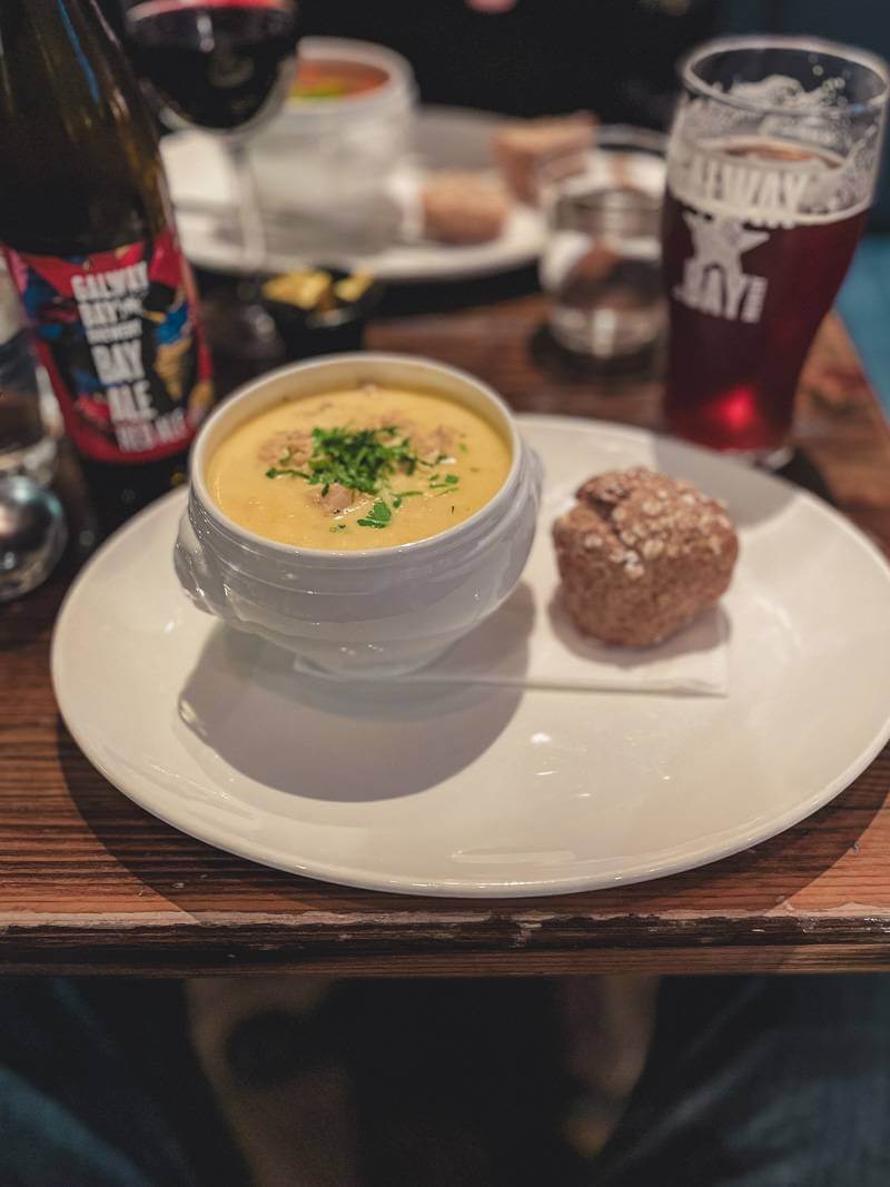 Warm bowl of soup on a wooden table in a cozy restaurant in Galway, Ireland