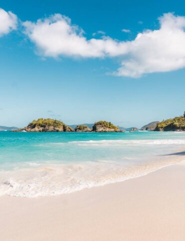 view of st john's trunk bay from left side of the beach towards trunk cay on calm clear day