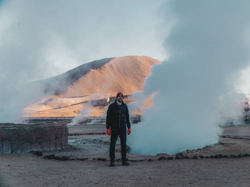 Man standing among the steam emitted from the Tatio Geysers in the Atacama Desert - Chile packing list