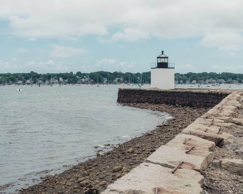 Derby Wharf Light Station jutting out into bay on cloudy day - Boston and Salem MA