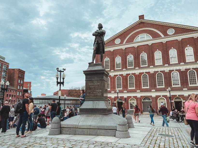 Samuel Adams statue in front of brick facade of Faneuil Hall - Boston and Salem MA