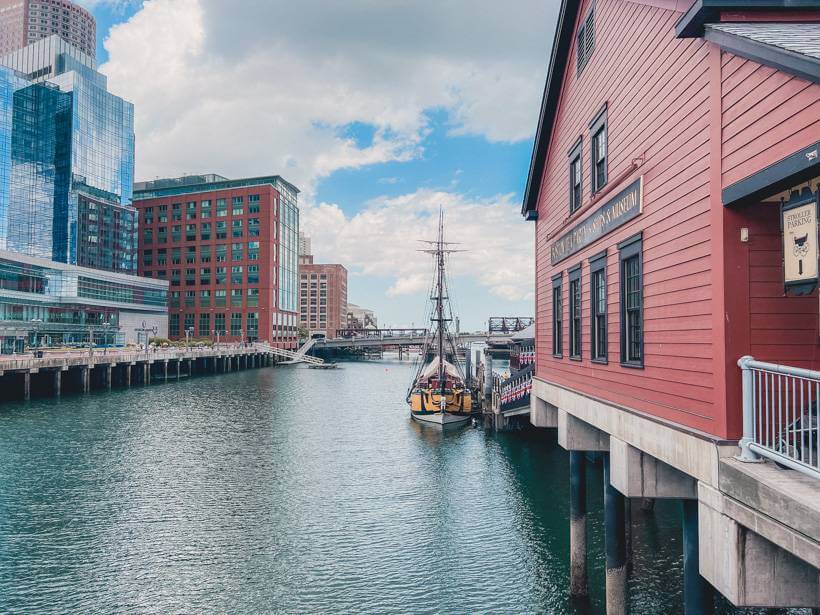Red-sided building and ship replica at Boston Tea Party Museum on Boston Harbor