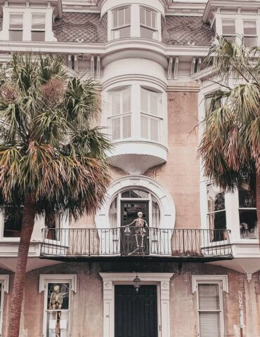 Mansion with pointy roof and skeleton decorations on gray overcast day during fall in Charleston SC