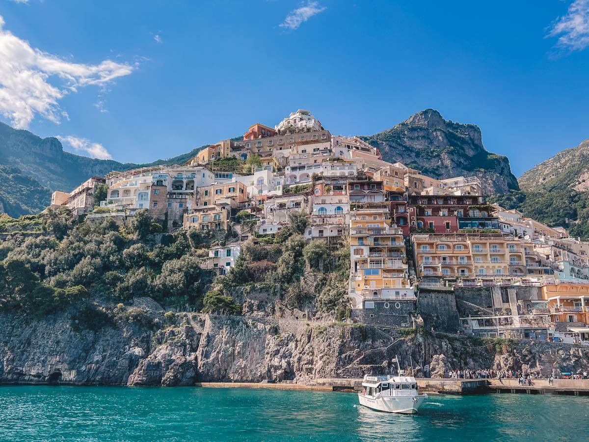 colorful buildings climbing up the cliffs of Positano - naples and amalfi coast itinerary